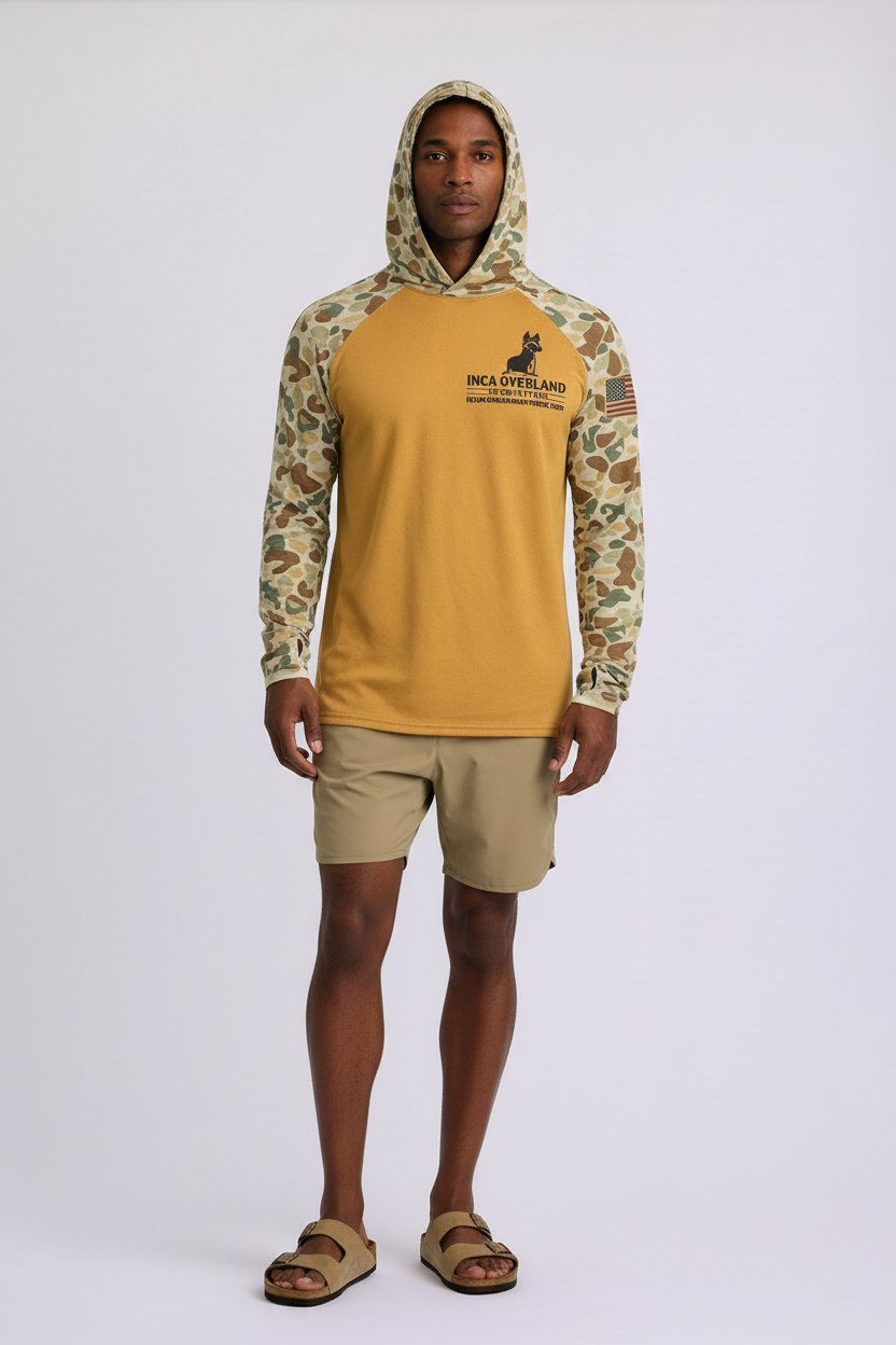 Person wearing a camouflage and yellow hoodie with a logo on a white background